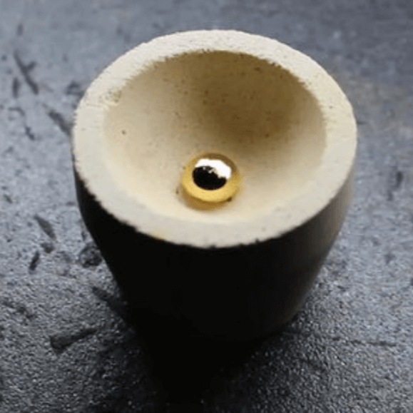 Mabor Magnesia Cupel showing gold bead, essential tool for gold and silver refining, designed to absorb impurities.