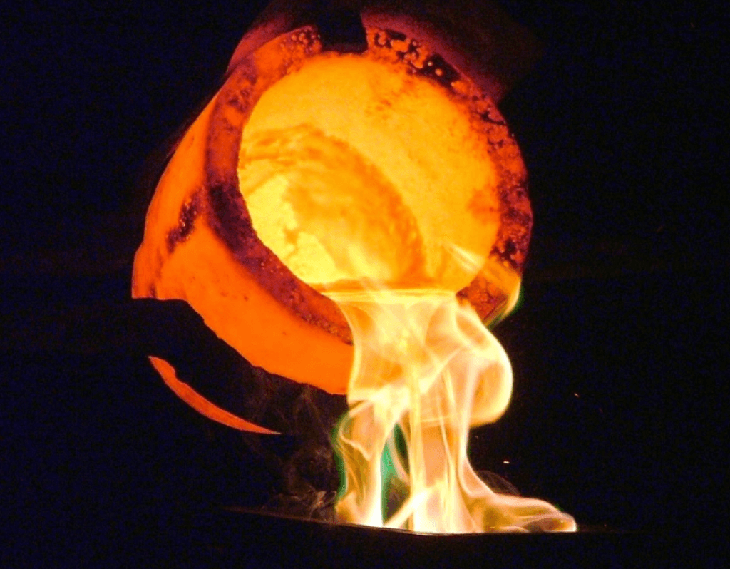 Molten metal pouring from a furnace, illustrating smelting and melting processes in metal purification.