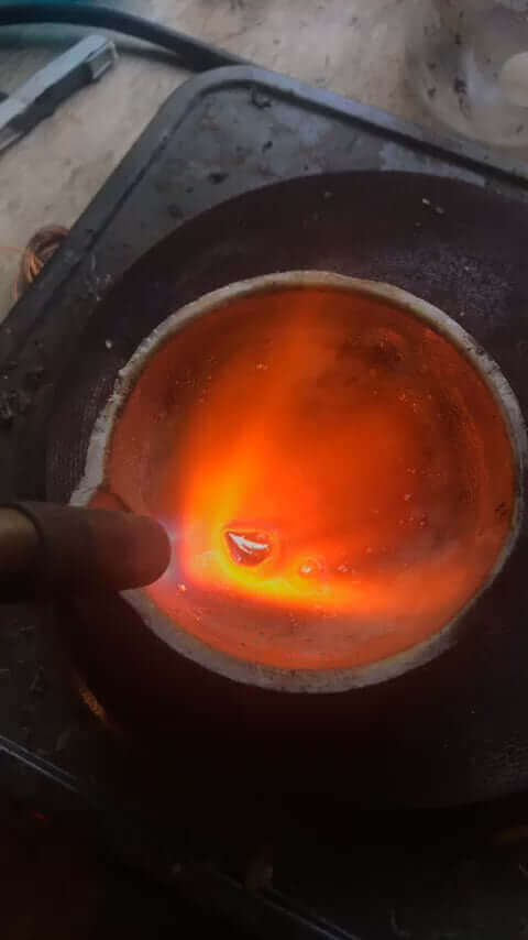 Melting precious metals in a 150 Gram ceramic alumina crucible with torch, showcasing high heat resistance.
